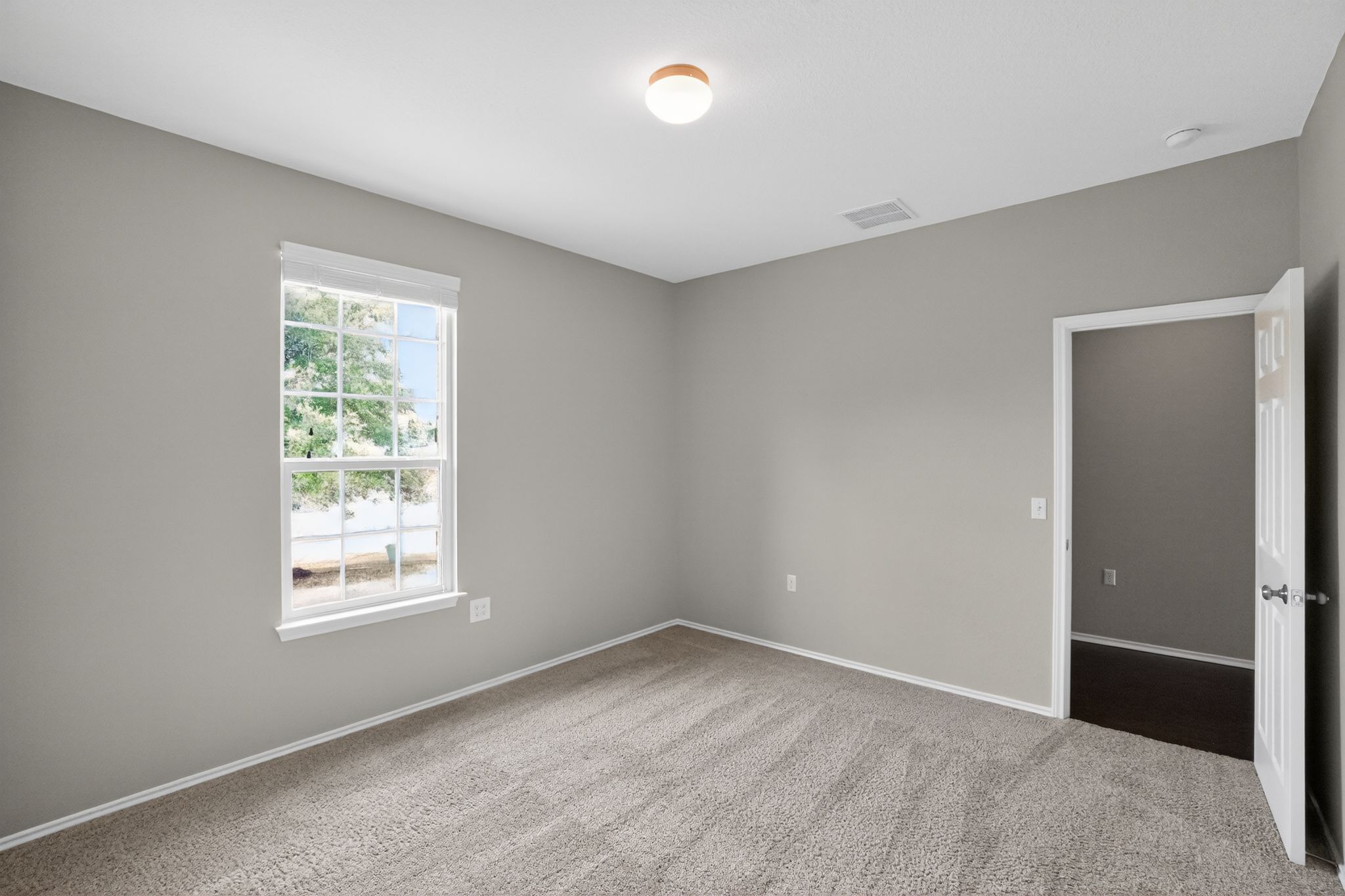 5816 Minch Road Austin, TX 78754 - Photo 5 of 15 This room features a window providing natural light, a neutral color palette, and carpeted flooring
