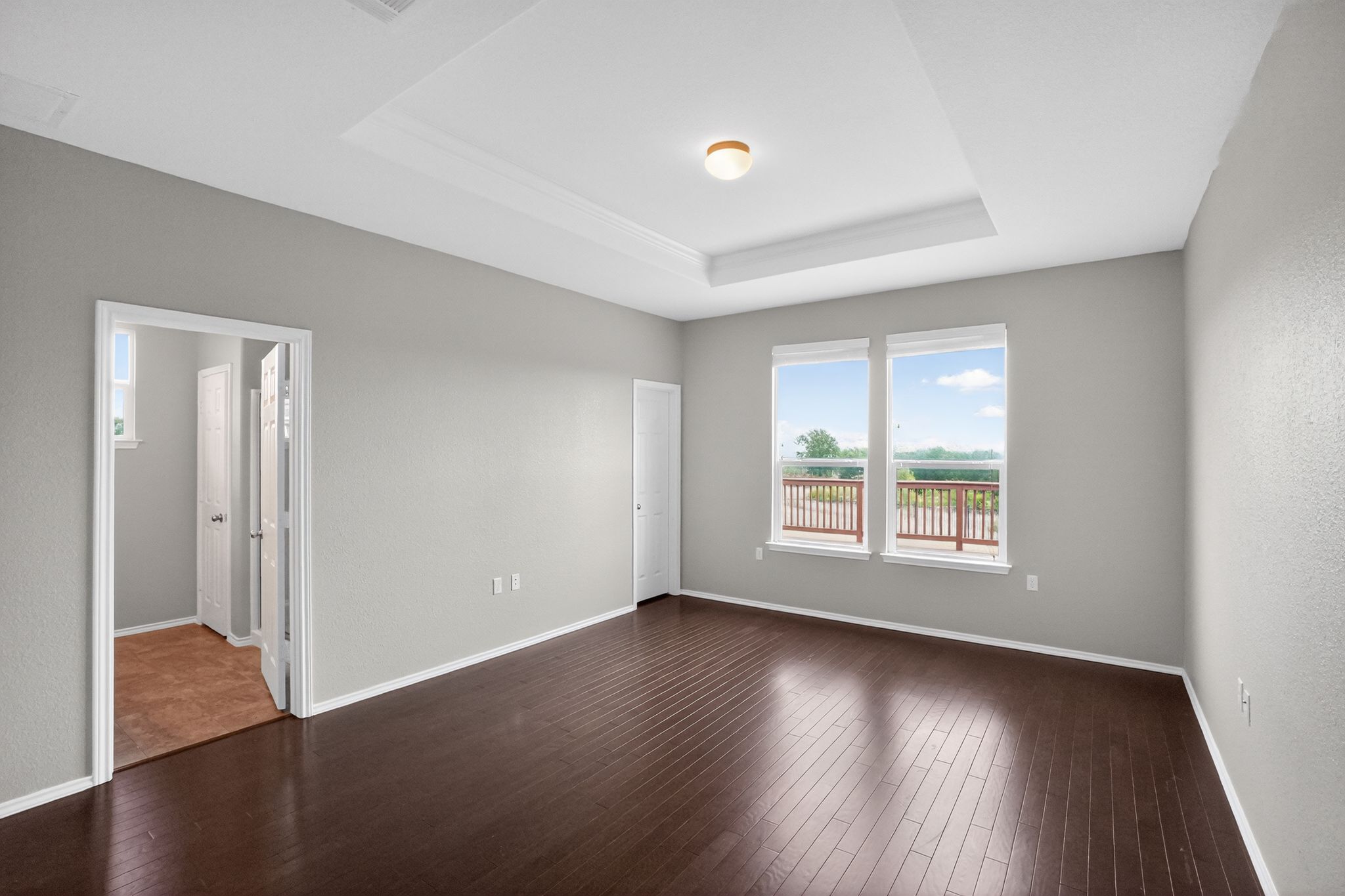 5816 Minch Road Austin, TX 78754 - Photo 6 of 15 Spacious room featuring dark wood flooring, light grey walls, and a recessed ceiling with a light fixture