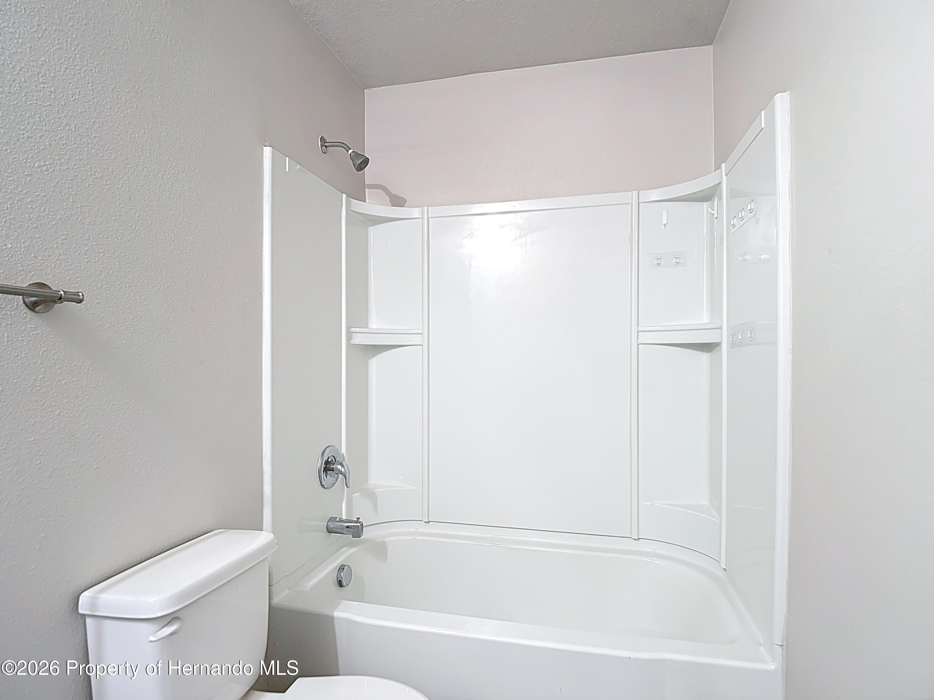 11374 Marcella Avenue Weeki Wachee, FL 34614 - Photo 56 of 70 a bathroom with a bathtub and a toilet