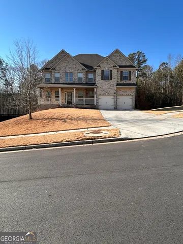 a view of pool with a yard and large tree