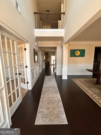 a view of a hallway with wooden floor and staircase