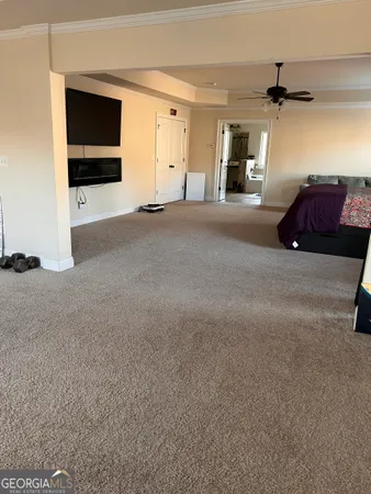 a bed sitting in a bedroom next to a window