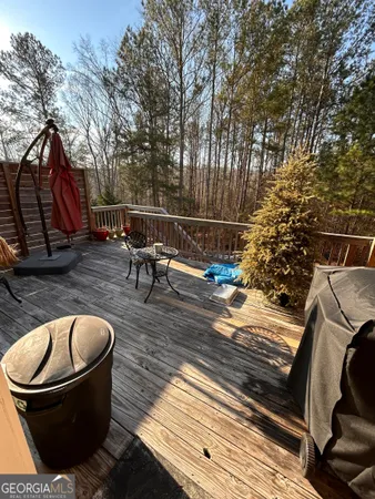 a view of balcony with wooden floor and fence