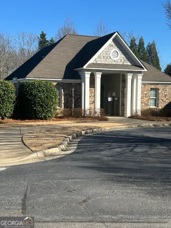 a view of a hallway with wooden floor and a chandelier