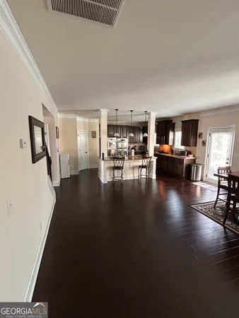 a view of a kitchen with granite countertop a sink and a stove