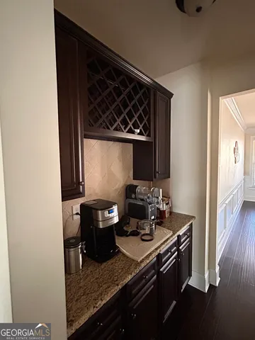 a view of a kitchen with granite countertop a sink and a stove