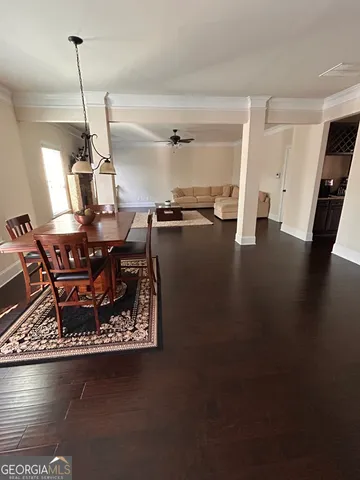 a living room with dining room and wooden floor