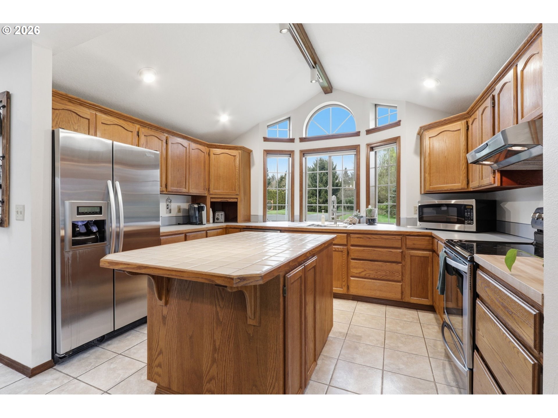 33954 Vista Lane Warren, OR 97053 - Photo 27 of 48 a kitchen with stainless steel appliances granite countertop a sink and a refrigerator