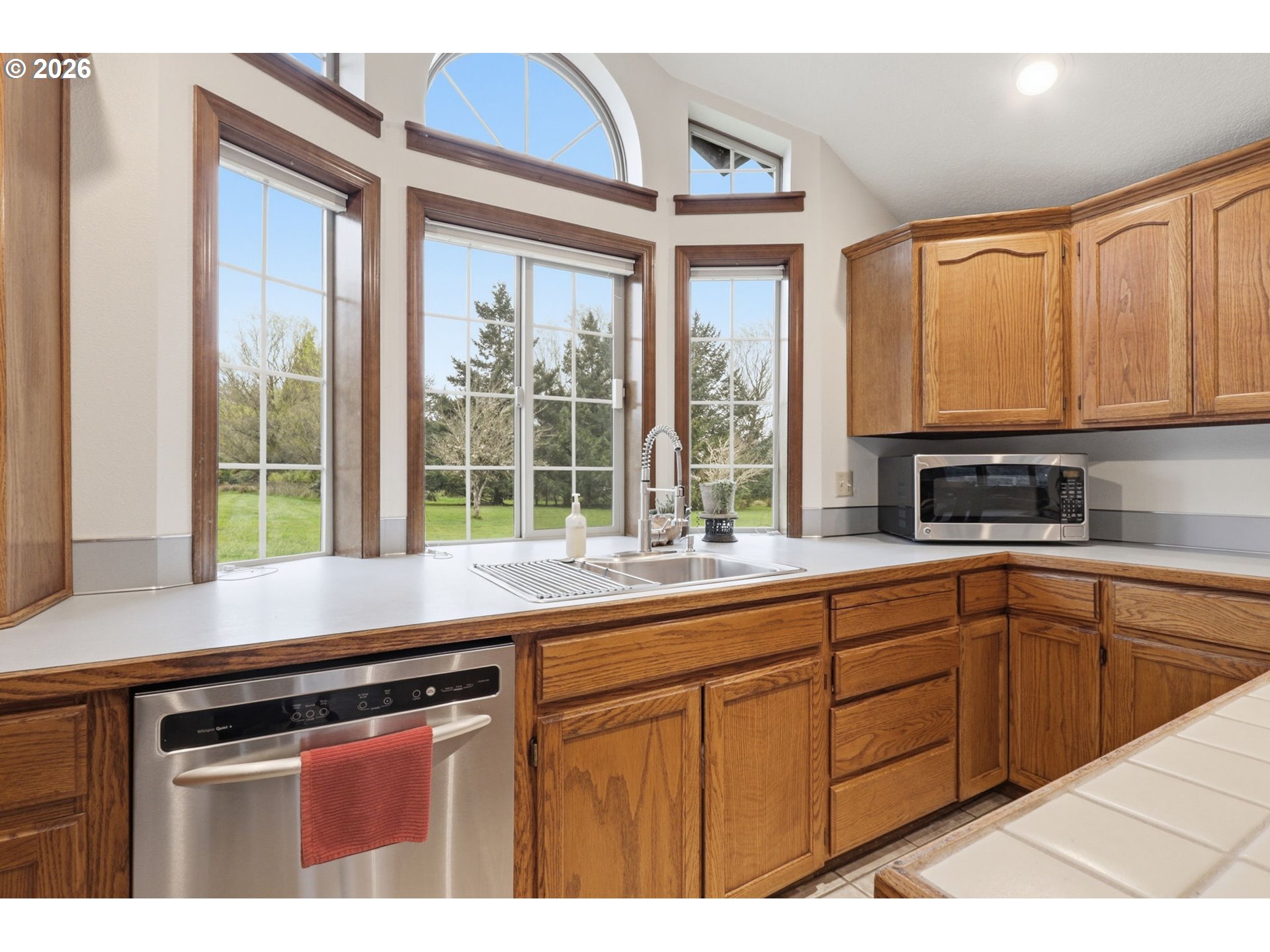 33954 Vista Lane Warren, OR 97053 - Photo 30 of 48 a kitchen with stainless steel appliances granite countertop a sink a stove and a microwave