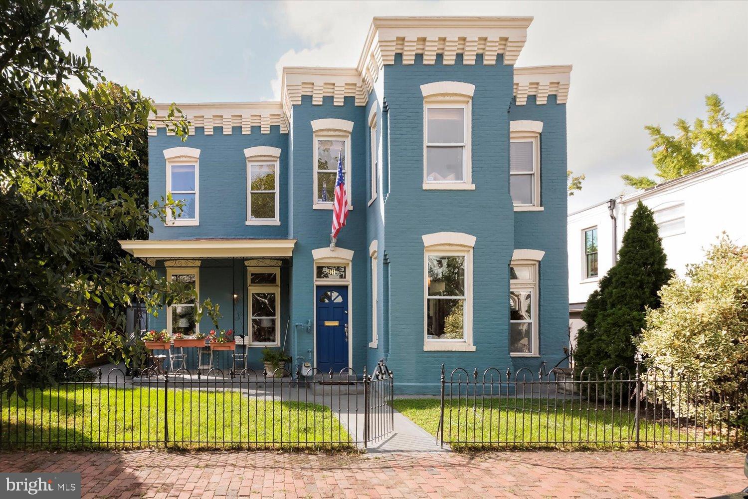 Charming blue Victorian with inviting porch.