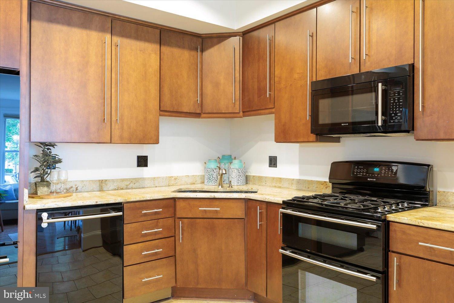 911 Independence Avenue Southeast Washington, DC 20003 - Photo 14 of 38 Modern kitchen with rich wood cabinetry.