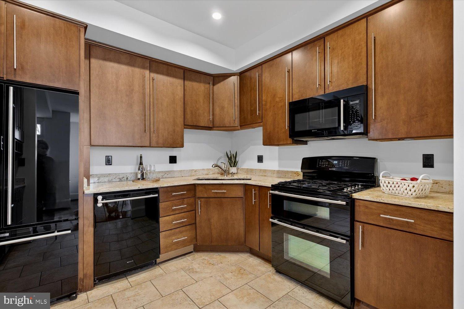 911 Independence Avenue Southeast Washington, DC 20003 - Photo 16 of 38 Sleek modern kitchen with rich wood cabinetry.