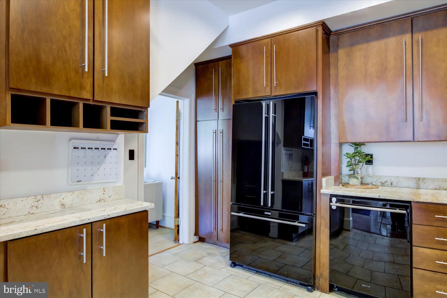 911 Independence Avenue Southeast Washington, DC 20003 - Photo 18 of 38 Sleek modern kitchen with rich wood accents.