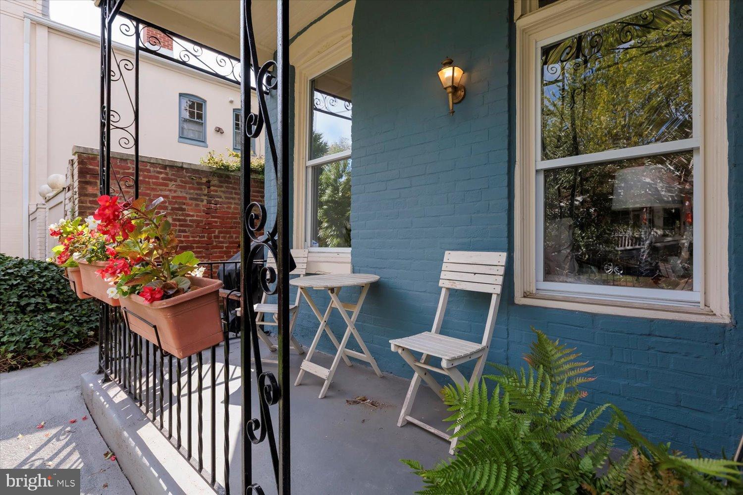 911 Independence Avenue Southeast Washington, DC 20003 - Photo 4 of 38 Charming porch with vibrant blooms.