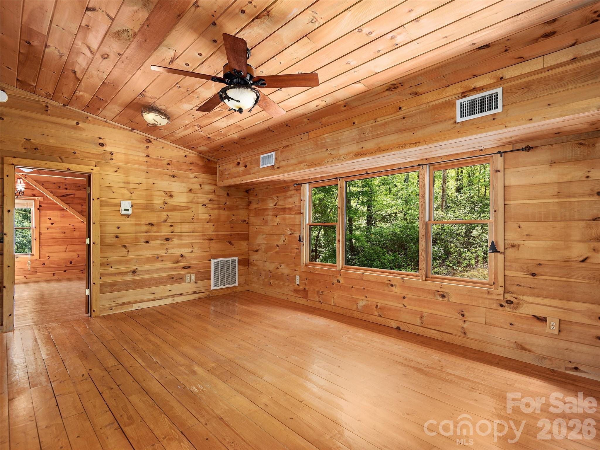 413 Green Hills Road Mill Spring, NC 28756 - Photo 23 of 48 a view of a room with a wooden floor and windows