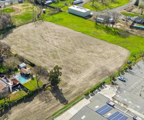 an aerial view of a house with a yard and a garage