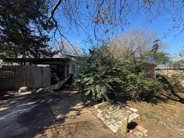 a backyard of a house with a tree