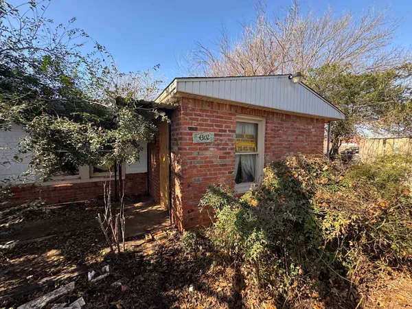 a brick building with a yard