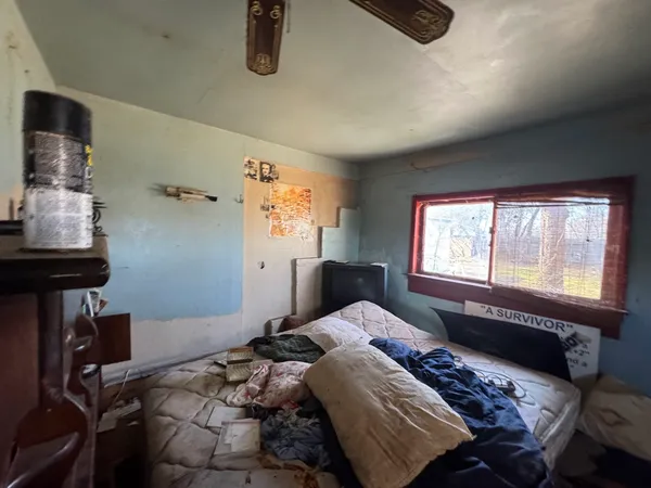 a bedroom with a bed and a window