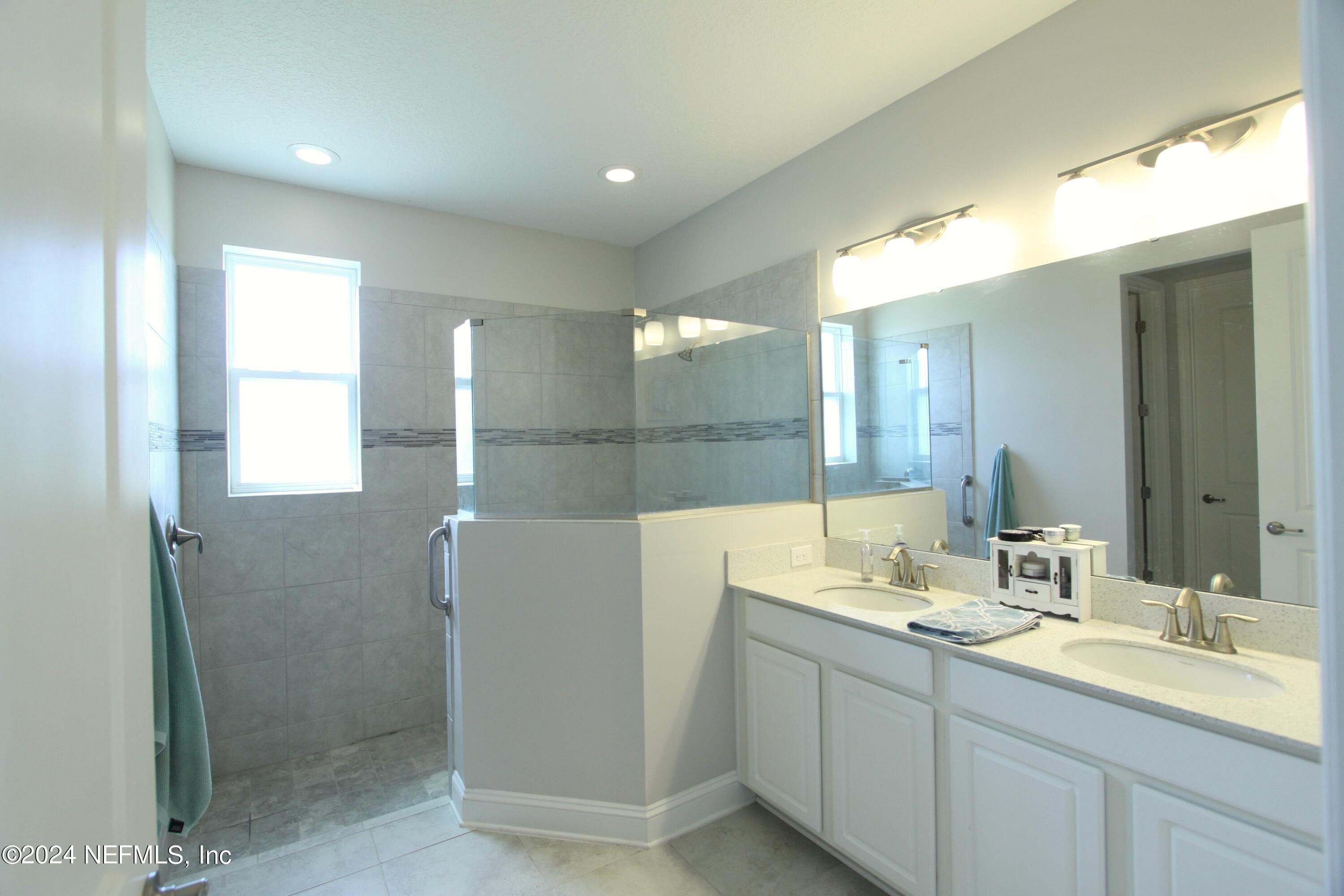 458 Convex Lane St. Augustine, FL 32095 - Photo 14 of 26 a bathroom with a double vanity sink mirror and double