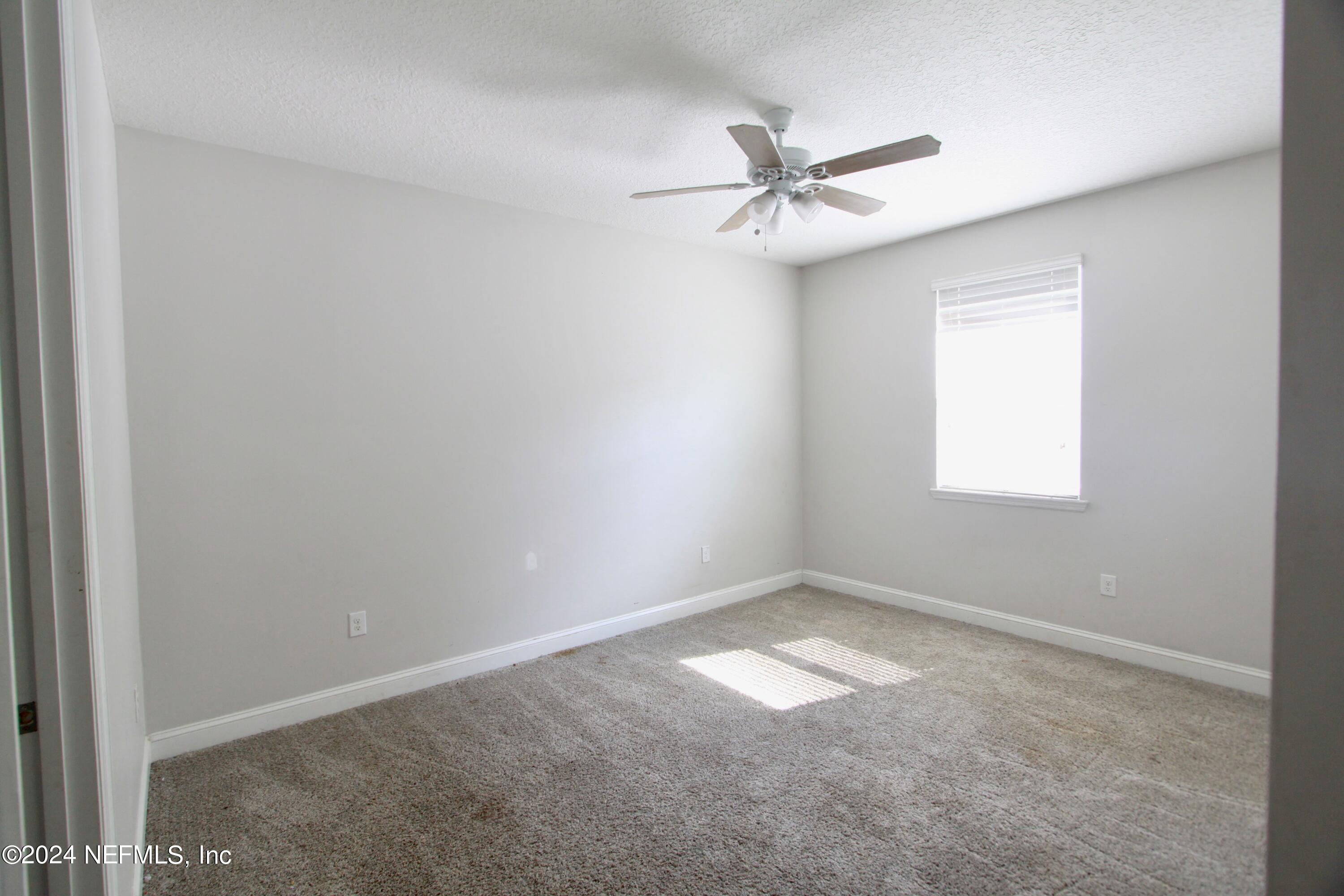 458 Convex Lane St. Augustine, FL 32095 - Photo 15 of 26 an empty room with windows and fan