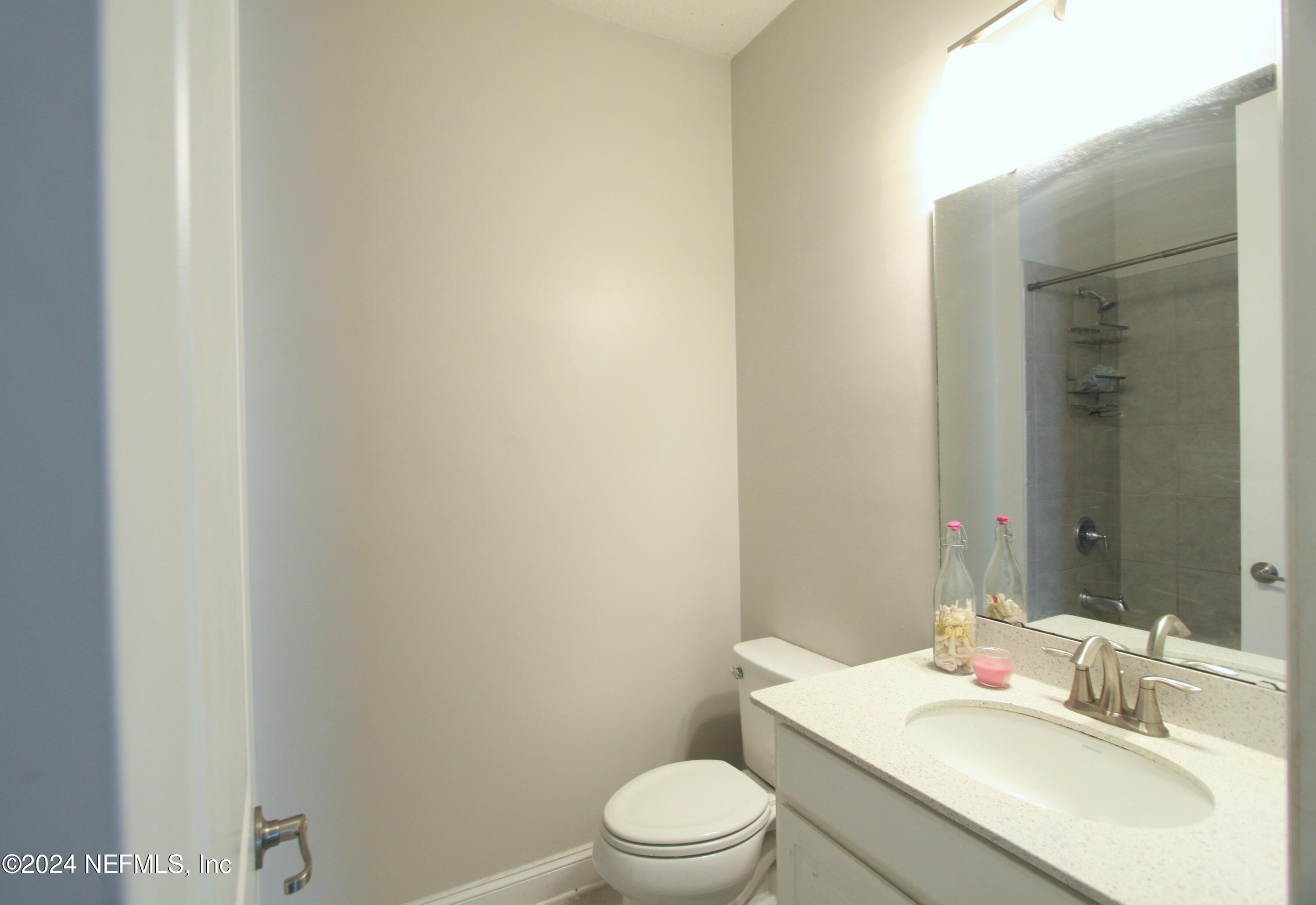 458 Convex Lane St. Augustine, FL 32095 - Photo 16 of 26 a bathroom with a sink a toilet and shower