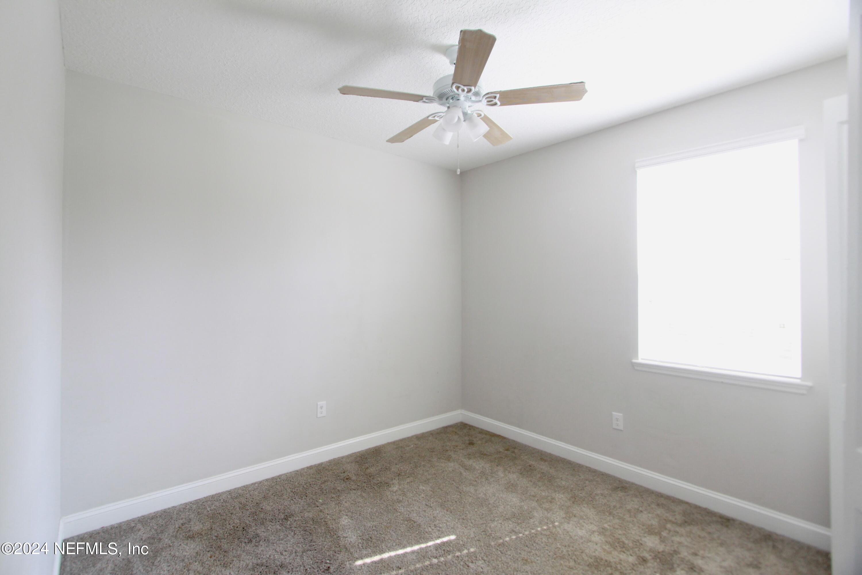458 Convex Lane St. Augustine, FL 32095 - Photo 17 of 26 an empty room with a window and a fan