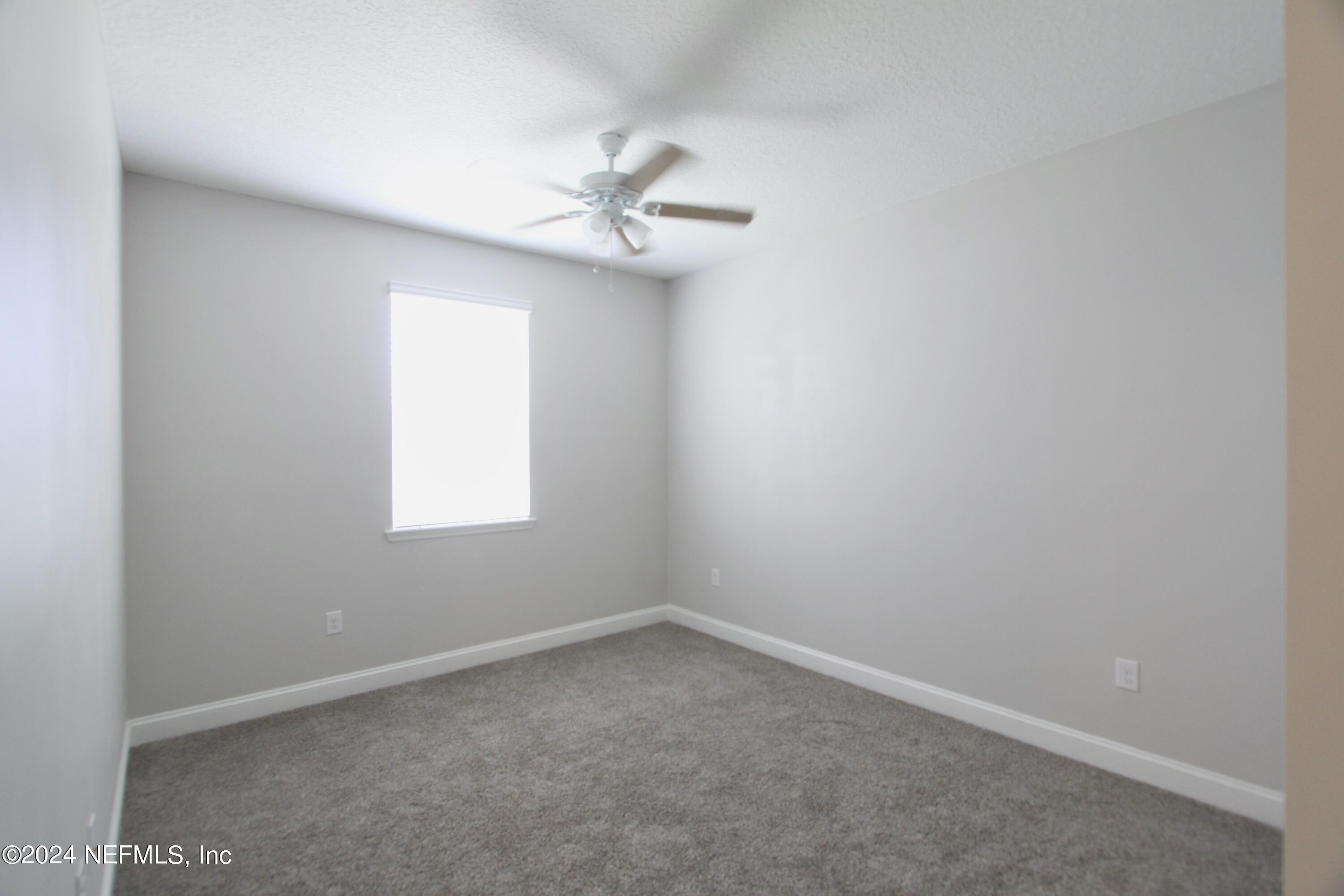 458 Convex Lane St. Augustine, FL 32095 - Photo 18 of 26 an empty room with a window and a fan