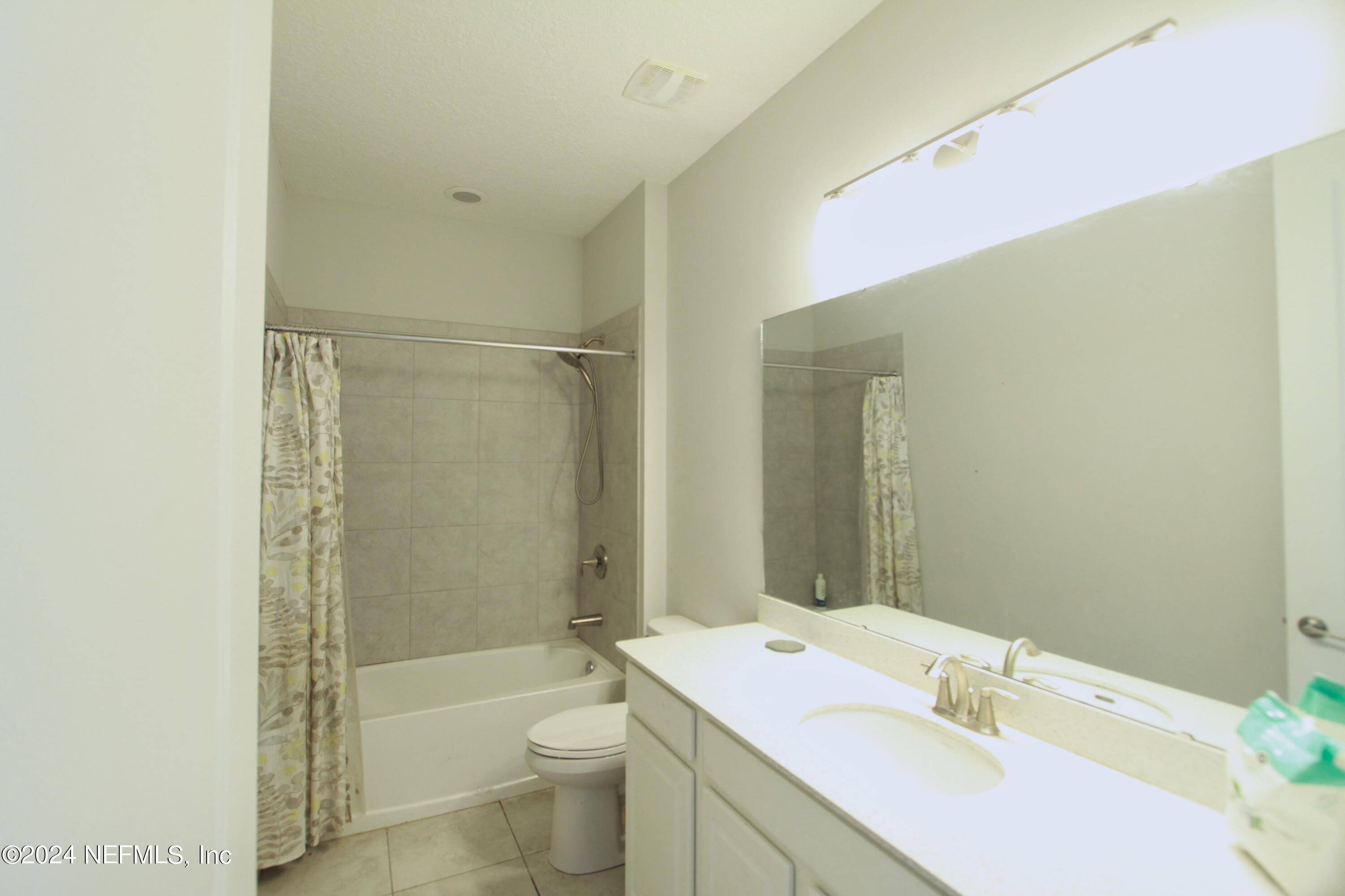 458 Convex Lane St. Augustine, FL 32095 - Photo 19 of 26 a bathroom with a sink a toilet and shower