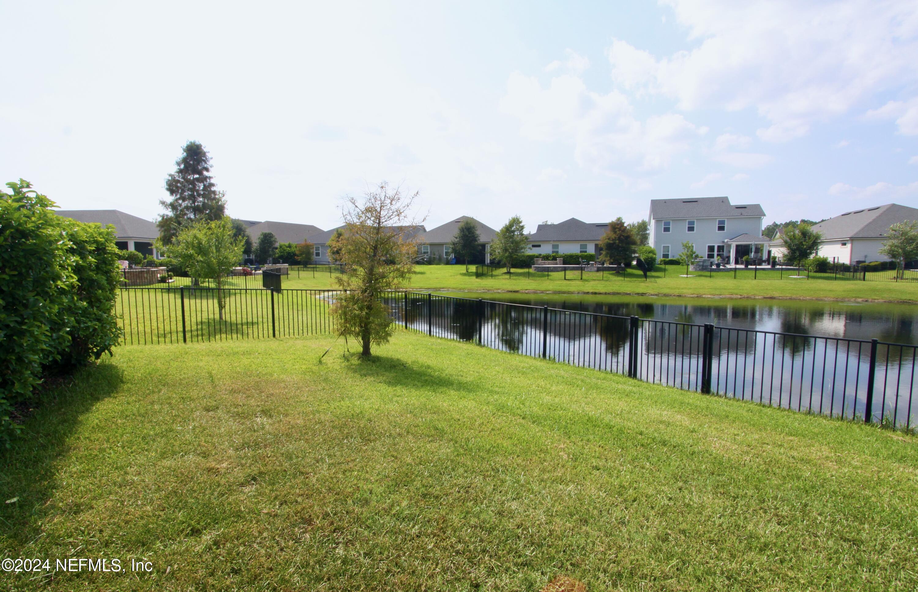 458 Convex Lane St. Augustine, FL 32095 - Photo 23 of 26 a view of a lake with a house in the background