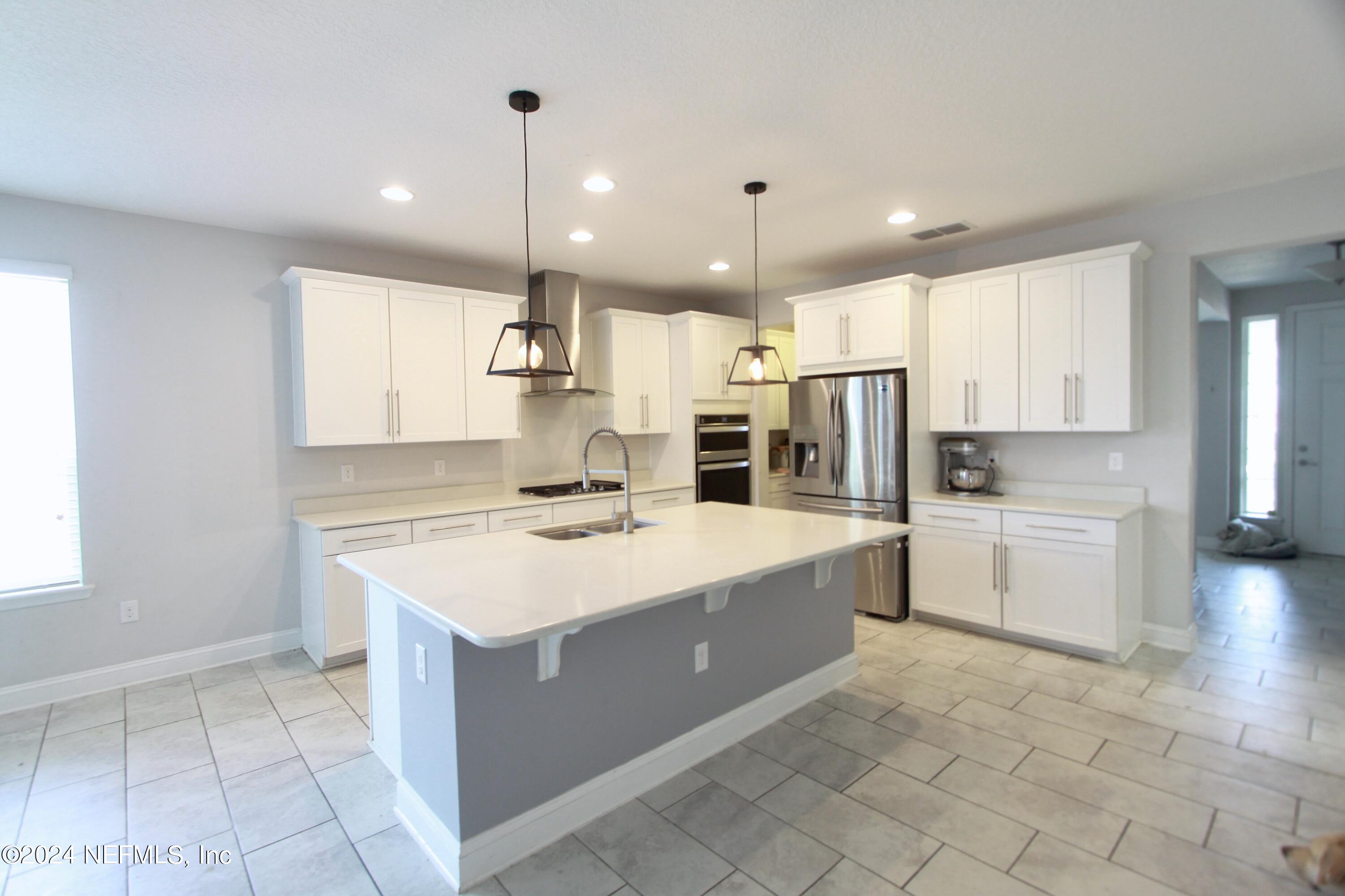458 Convex Lane St. Augustine, FL 32095 - Photo 3 of 26 a kitchen with a sink stove and refrigerator