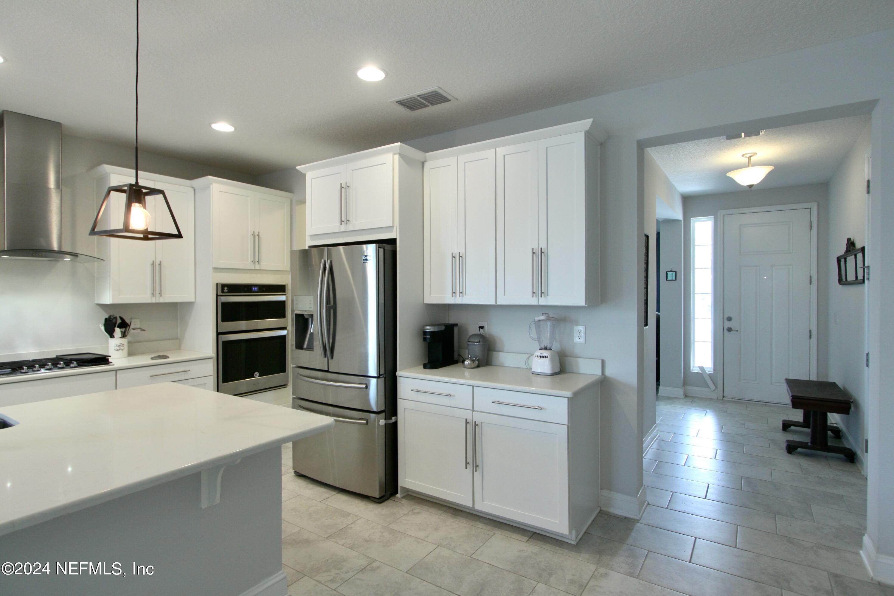 458 Convex Lane St. Augustine, FL 32095 - Photo 5 of 26 a kitchen with a sink stainless steel appliances and cabinets