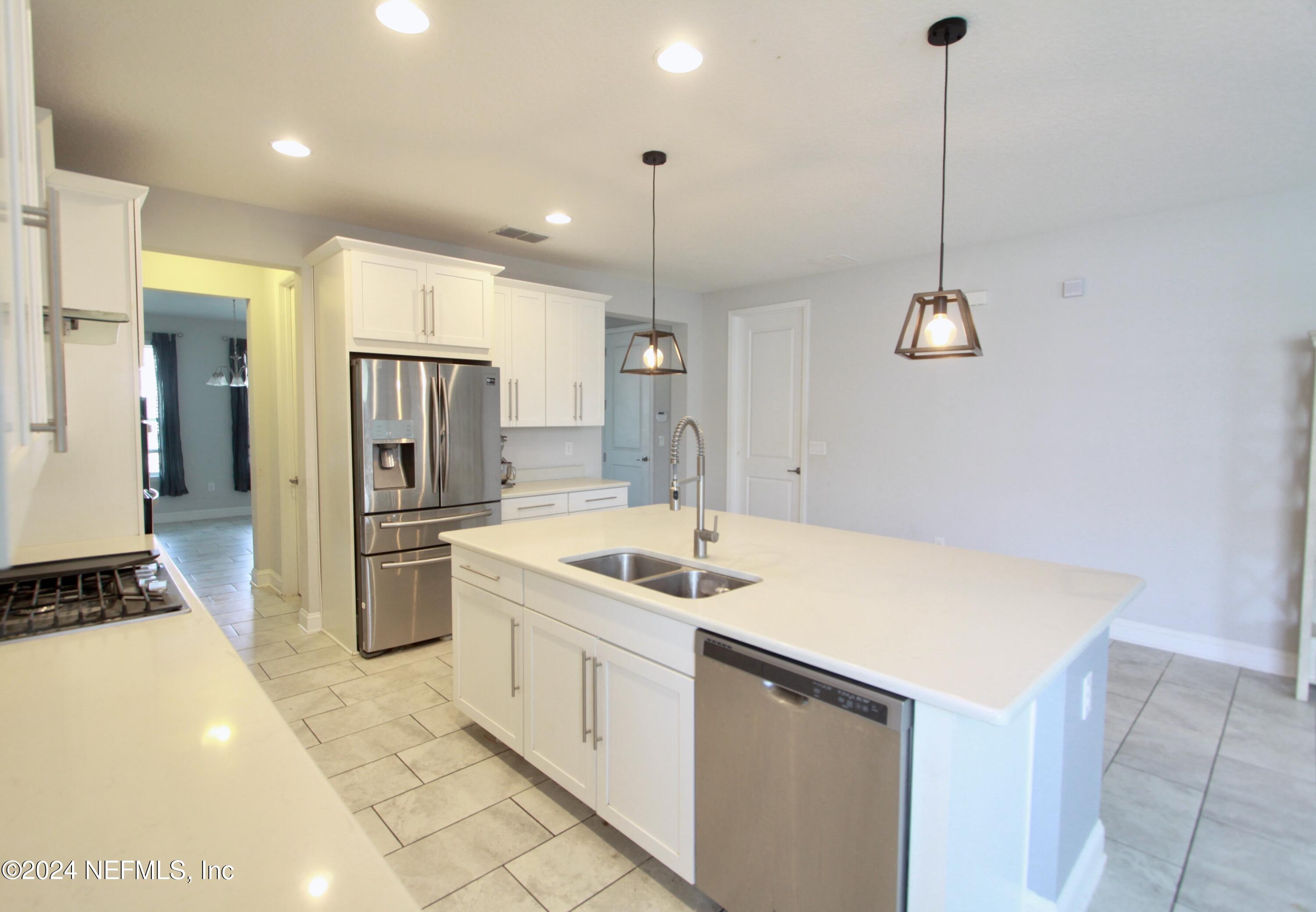 458 Convex Lane St. Augustine, FL 32095 - Photo 7 of 26 a kitchen that has a refrigerator a sink and a stove