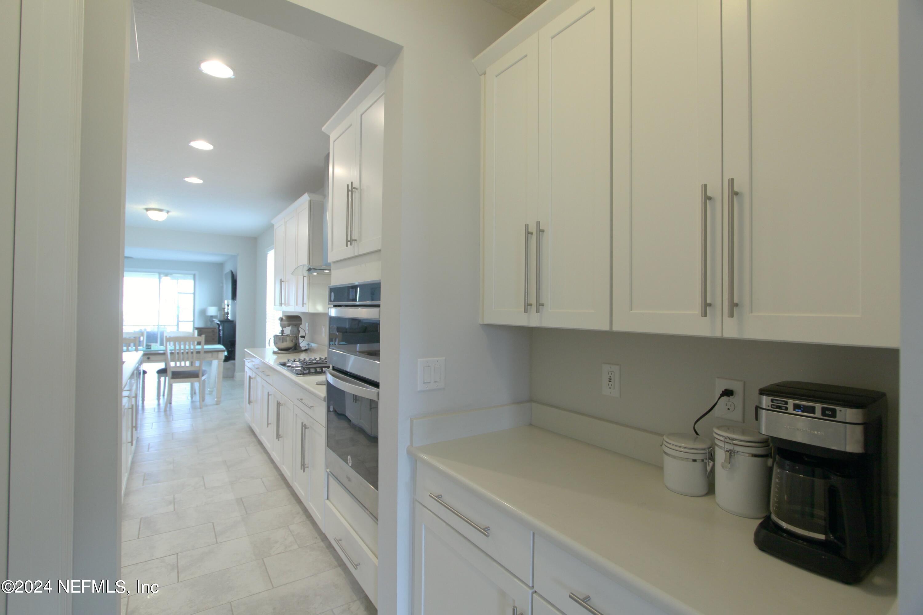 458 Convex Lane St. Augustine, FL 32095 - Photo 8 of 26 a kitchen with stainless steel appliances granite countertop a refrigerator and a stove top oven