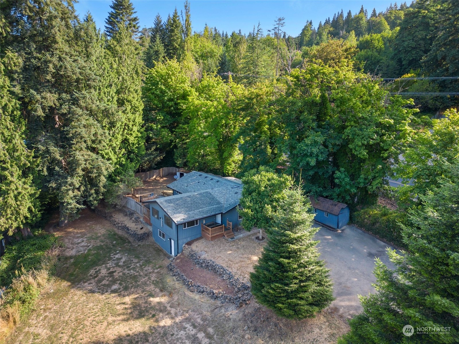 405 Coal Creek Road Longview, WA 98632 - Photo 3 of 40 a wooden bench sitting in middle of a forest