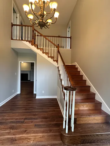 a view of entryway and hall with wooden floor