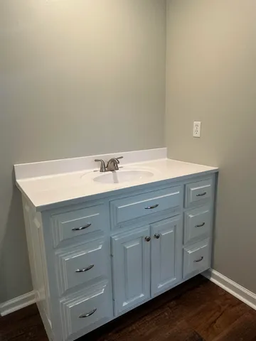 a bathroom with a sink vanity and mirror