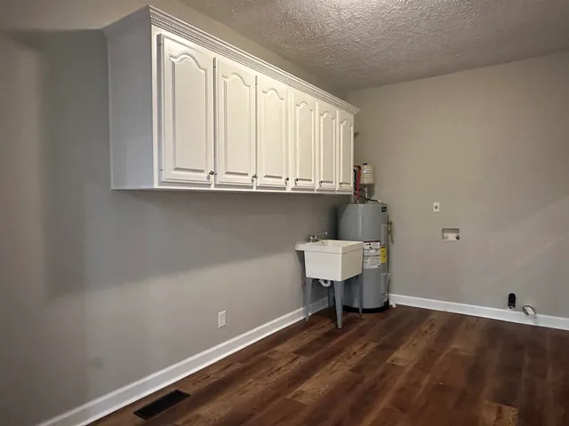 a room with a wooden floor and a window