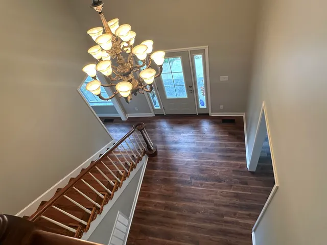 a view of entryway and hall with wooden floor