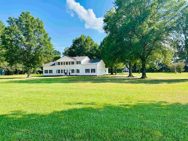 a view of swimming pool with tree and green space