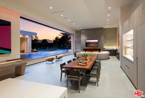 a dining room with furniture and a kitchen view