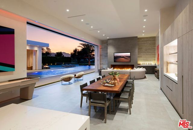 a dining room with furniture and a kitchen view
