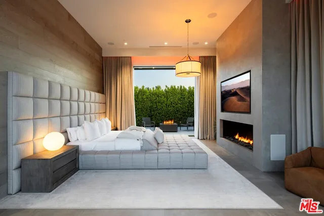 a bedroom with a bed and a fireplace