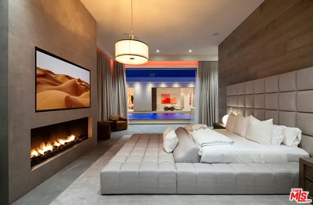 a bedroom with a bed and a fireplace