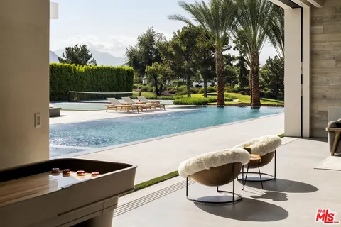 a swimming pool with outdoor seating and yard