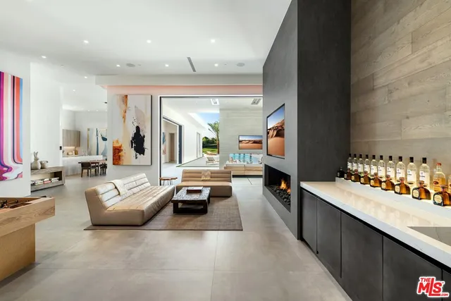 a dining room with furniture and a kitchen view
