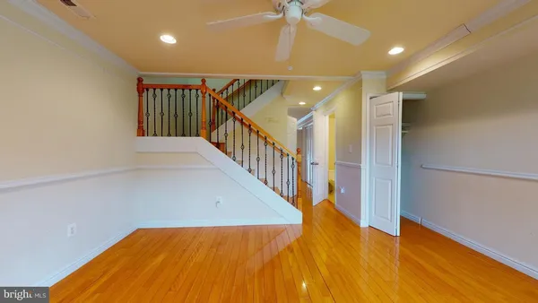 a view of a hallway with wooden floor