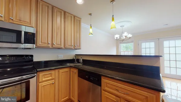 a kitchen with stainless steel appliances granite countertop a refrigerator and a cabinets
