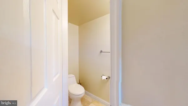 a bathroom with a granite countertop toilet and a sink