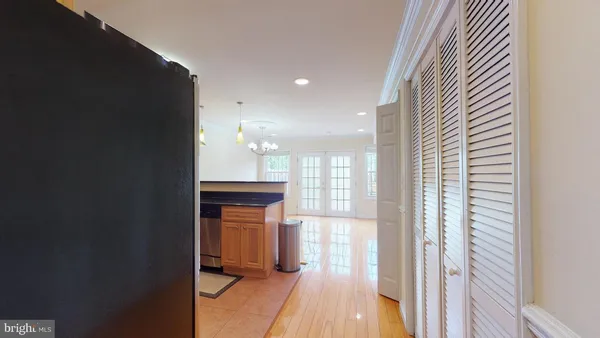 a view of a hallway with wooden floor and staircase